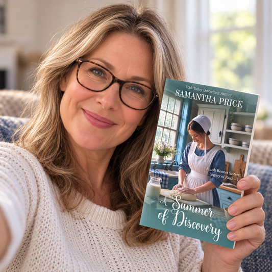 A smiling woman with glasses takes a selfie while holding up a book titled 'Summer of Discovery' by Samantha Price. The book cover features a teal background with an image of a woman in a kitchen.